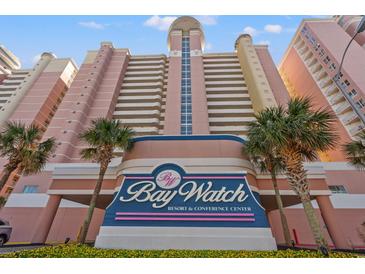 View of the Bay Watch Resort & Conference Center with tropical landscaping in front at 2801 S Ocean Blvd. # 941, North Myrtle Beach, SC 29582