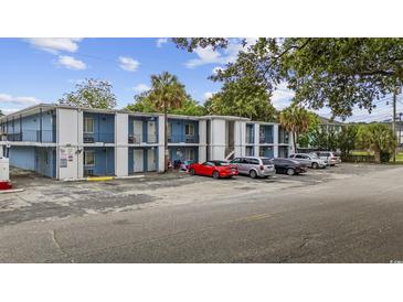 Two-story apartment building with a parking lot, blue and white paint job, and palm trees around it at 403 14Th Ave. S, Myrtle Beach, SC 29572