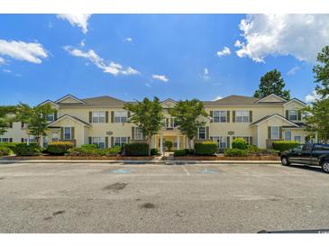 Low angle of condo exterior with yellow siding, green shutters, and handicap parking at 4430-G Montrose Ln. # G, Myrtle Beach, SC 29579