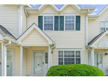 Charming townhome featuring teal shutters, neutral siding, and well-maintained landscaping at 613 S 2Nd Ave. # 21D, North Myrtle Beach, SC 29582