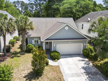 Charming single-story home featuring a two-car garage, manicured landscaping, and inviting curb appeal at 618 5Th Ave. S, North Myrtle Beach, SC 29582