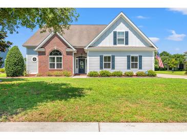 Charming single-Gathering home with manicured lawn and classic architectural details at 1025 Limpkin Dr., Conway, SC 29526