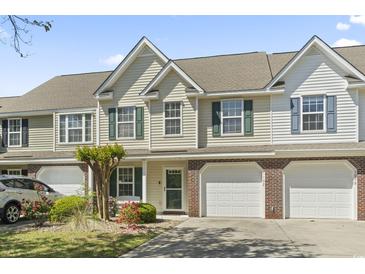 Charming townhome featuring a one car garage and landscaped front yard at 1102 Stanton Pl. # 1102, Myrtle Beach, SC 29579