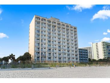 Exterior view of a high-rise condominium building on a sunny day, located directly on a sandy beach at 1207 S Ocean Blvd. # 20109, Myrtle Beach, SC 29577