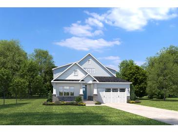 Charming two-story home with a well-manicured lawn and attached two-car garage at 1416 Whistling Straits Way, Sunset Beach, NC 28468