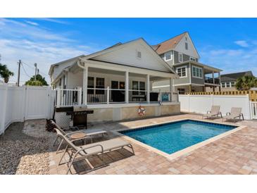 Inviting pool with lounge chairs and grill, perfect for outdoor relaxation and entertaining at 1616 S Ocean Blvd., North Myrtle Beach, SC 29582