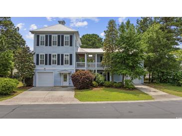 Charming two-story home with a well-manicured lawn, a garage and inviting curb appeal at 175 Summer Wind Loop, Murrells Inlet, SC 29576