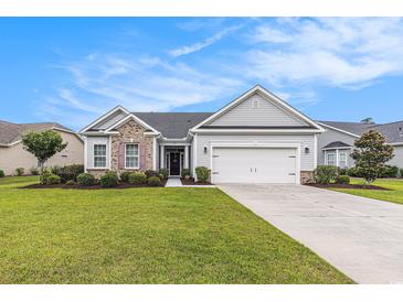 Charming single-story home with a well-manicured lawn, two-car garage, and nicely landscaped garden at 364 Palm Lakes Blvd., Little River, SC 29566
