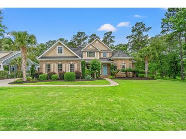 Charming home boasts a manicured lawn, lush landscaping, and a welcoming entrance at 528 Chamberlin Rd., Myrtle Beach, SC 29588