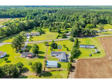Expansive aerial view of a single-Gathering home, including a detached garage and the surrounding, lush green landscape at 5589 Highway 668, Conway, SC 29526