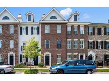 Charming townhouses with brick and white siding exteriors, dormer windows, and landscaped front yards at 861 Murray Ave., Myrtle Beach, SC 29577