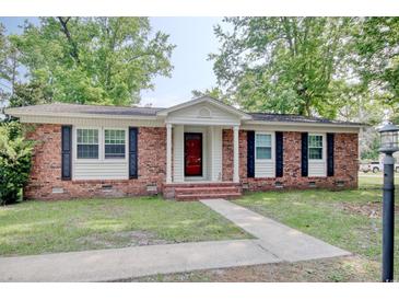 Charming brick home with a well-maintained lawn and inviting front entrance at 900 47Th Ave. N, Myrtle Beach, SC 29577