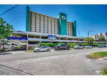 Exterior view of Royal Garden Resort featuring a multi-level parking garage and partial view of the building at 1210 N Waccamaw Dr. # 602, Murrells Inlet, SC 29576