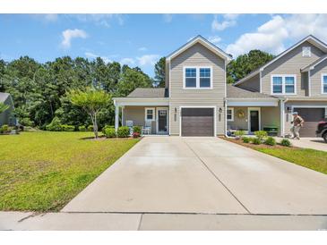 Charming two-story townhome featuring a well-manicured lawn and a private garage at 132 Machrie Loop # A, Myrtle Beach, SC 29588