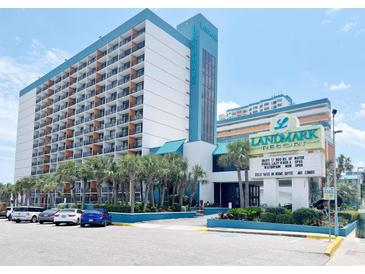 Bright oceanfront view of the Landmark Resort with palm trees and on-site parking at 1501 S Ocean Blvd. # 239, Myrtle Beach, SC 29577