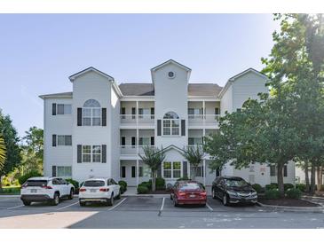Three-story condo with white siding, black shutters, and multiple balconies at 1505 Lantern Rest Dr. # 301, Myrtle Beach, SC 29579
