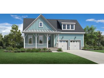 Charming two-story home featuring a welcoming front porch, two-car garage, and beautifully landscaped front yard at 1773 Tryon Dr, Myrtle Beach, SC 29588