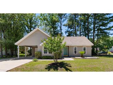 Charming single-story home featuring a covered carport and a well-manicured lawn at 250 Nature Trail, Little River, SC 29566