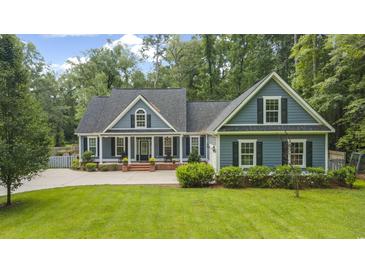 Charming home featuring blue siding, black shutters, and a well-manicured lawn at 3180 Long Avenue Ext., Conway, SC 29526