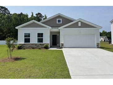 Charming single-story home with a well-manicured lawn and attached garage at 331 Garden Grove St, Conway, SC 29526