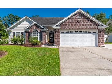 Charming single-story home with a well-manicured lawn, brick accents, and an attached two-car garage at 359 Harbour Reef Dr., Myrtle Beach, SC 29588