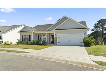 Charming single-story home with a well-manicured lawn and a two-car garage, offering great curb appeal at 417 Grain Field Dr., Georgetown, SC 29440