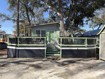 Charming coastal home featuring a spacious front deck and lush greenery at 6001-Z67 S Kings Hwy., Myrtle Beach, SC 29575