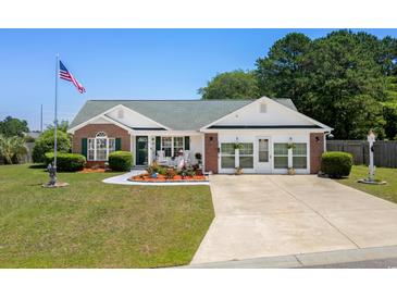 Charming home featuring a beautifully landscaped front yard, inviting entryway and brick accents at 601 Jousting Ct., Conway, SC 29526