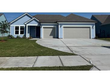 Charming light blue single-story home features a two-car garage, well-maintained lawn, and inviting curb appeal at 1345 Crested Iris Way, North Myrtle Beach, SC 29582
