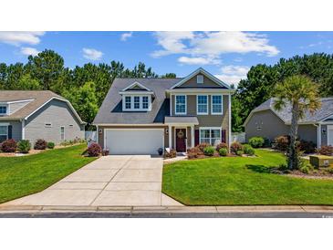Charming two-story home featuring a well-maintained lawn, two car garage, and inviting front porch at 284 Whipple Run, Myrtle Beach, SC 29588