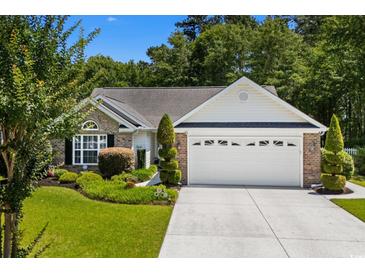 Charming single-story home with manicured lawn, brick facade, and two-car garage at 4 Clemson Rd., Conway, SC 29526