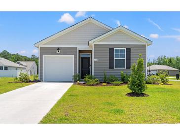 Charming single-story home featuring a one-car garage, nicely manicured lawn, and classic curb appeal at 402 Toledo St., Conway, SC 29526