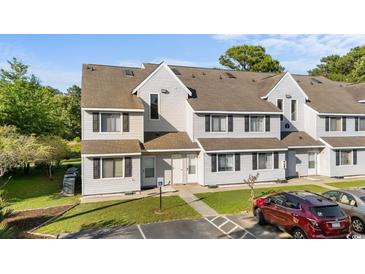 Inviting townhouse with gray siding, multiple windows, and well-maintained landscaping at 500 Fairway Village Dr. # 3-L, Myrtle Beach, SC 29588