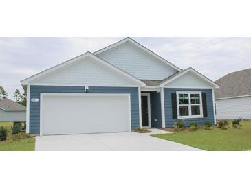 Charming single-Gathering home featuring a two-car garage and a mix of lap siding and shingles on the facade at 5141 Yellowstone Dr., Conway, SC 29526
