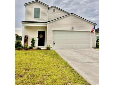 Charming home featuring a two-car garage, and a manicured lawn, displaying classic suburban appeal at 8211 Forest Edge Dr., Myrtle Beach, SC 29579