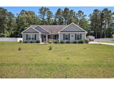 Charming single-story home featuring a well-manicured lawn and quaint landscaping at 95 Timber Run Dr., Georgetown, SC 29440