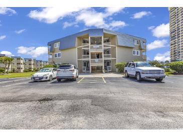 Seagull condominium featuring multiple stories with blue roof accents and ample parking at 9660 Shore Dr. # 208, Myrtle Beach, SC 29572