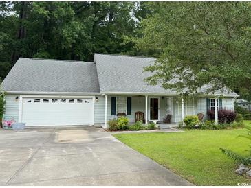 Charming single-story home with a well-manicured lawn, attached garage, and inviting front porch at 125 Gavin Hill Ct., Aynor, SC 29511