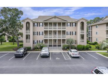 Three-story condo building with parking and covered balconies at 1900 Duffy St. # H-8, North Myrtle Beach, SC 29582