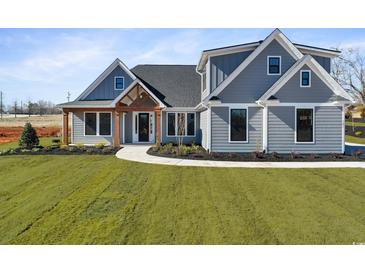 Beautiful single Gathering home showcasing impeccable landscaping and craftsman style architecture at 2729 Long Avenue Ext., Conway, SC 29526