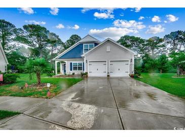 Charming two-story home with a two-car garage, well-manicured lawn and landscaping at 3091 Viceroy Loop, Little River, SC 29566