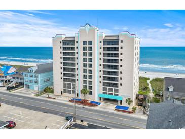 Oceanfront condo building with beach views, covered parking, and well-maintained landscaping at 4000 N Ocean Blvd. # 506, North Myrtle Beach, SC 29582