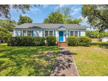 Charming single story home with blue door, blue shutters and well-maintained front yard at 1155 Palmetto St., Georgetown, SC 29440