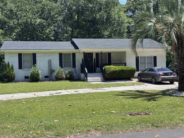 Charming single-story home featuring a brick facade, manicured lawn, and mature trees at 1903 Rose St., Conway, SC 29527