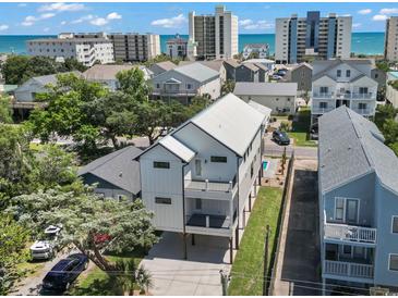 Stunning aerial view of the modern home, showcasing the backyard pool and proximity to the ocean at 4617 Hedrick St., North Myrtle Beach, SC 29582