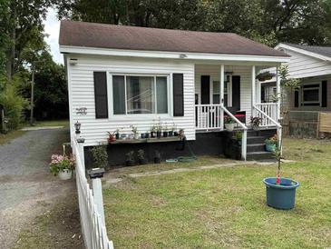 Charming home featuring white siding, dark shutters, and a cozy front porch at 514 Palm St., Georgetown, SC 29440