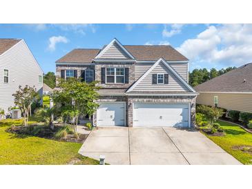 Charming two-story home with a brick and siding exterior and a spacious three-car garage at 5621 Camilla Ct., Myrtle Beach, SC 29579