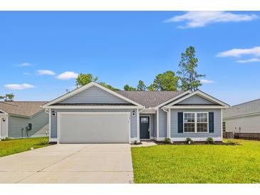 Charming one-story home with a well-manicured lawn, attached garage, and inviting entrance at 600 Woodside Dr., Conway, SC 29526