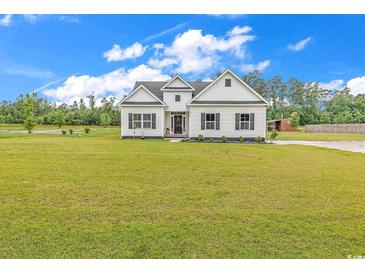 Charming one-story home with black shutters and a spacious front yard at 7377 Pauley Swamp Rd., Conway, SC 29527