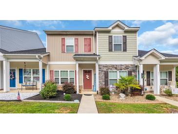 Charming townhome with manicured landscaping and inviting red front door at 837 Triple Ct. # 837, Myrtle Beach, SC 29588
